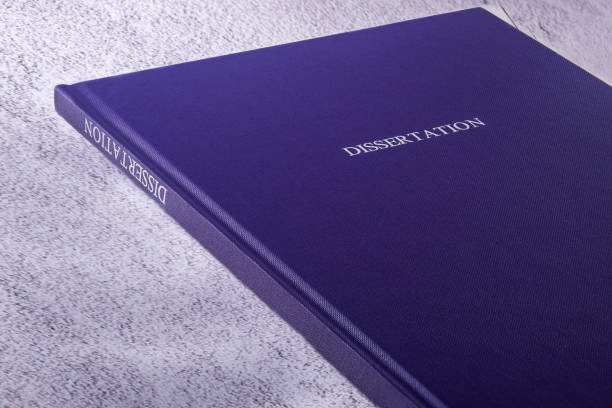 Deep purple dissertation book binding with white text on textured surface