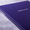 Deep purple dissertation book binding with white text on textured surface