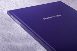 Deep purple dissertation book binding with white text on textured surface