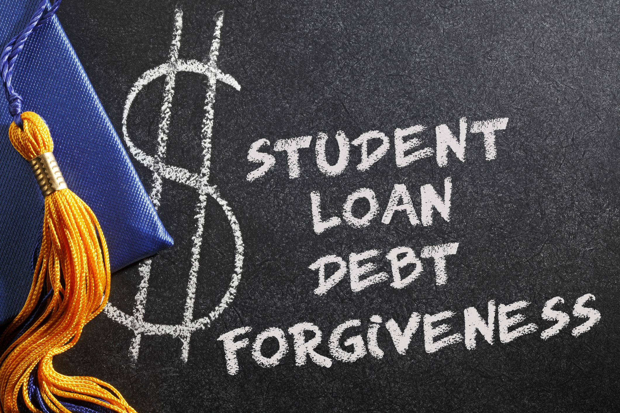 Chalkboard with dollar sign symbol and text reading 'Student Loan Debt Forgiveness' next to graduation cap with gold tassel