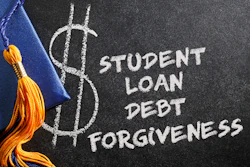 Chalkboard with dollar sign symbol and text reading 'Student Loan Debt Forgiveness' next to graduation cap with gold tassel