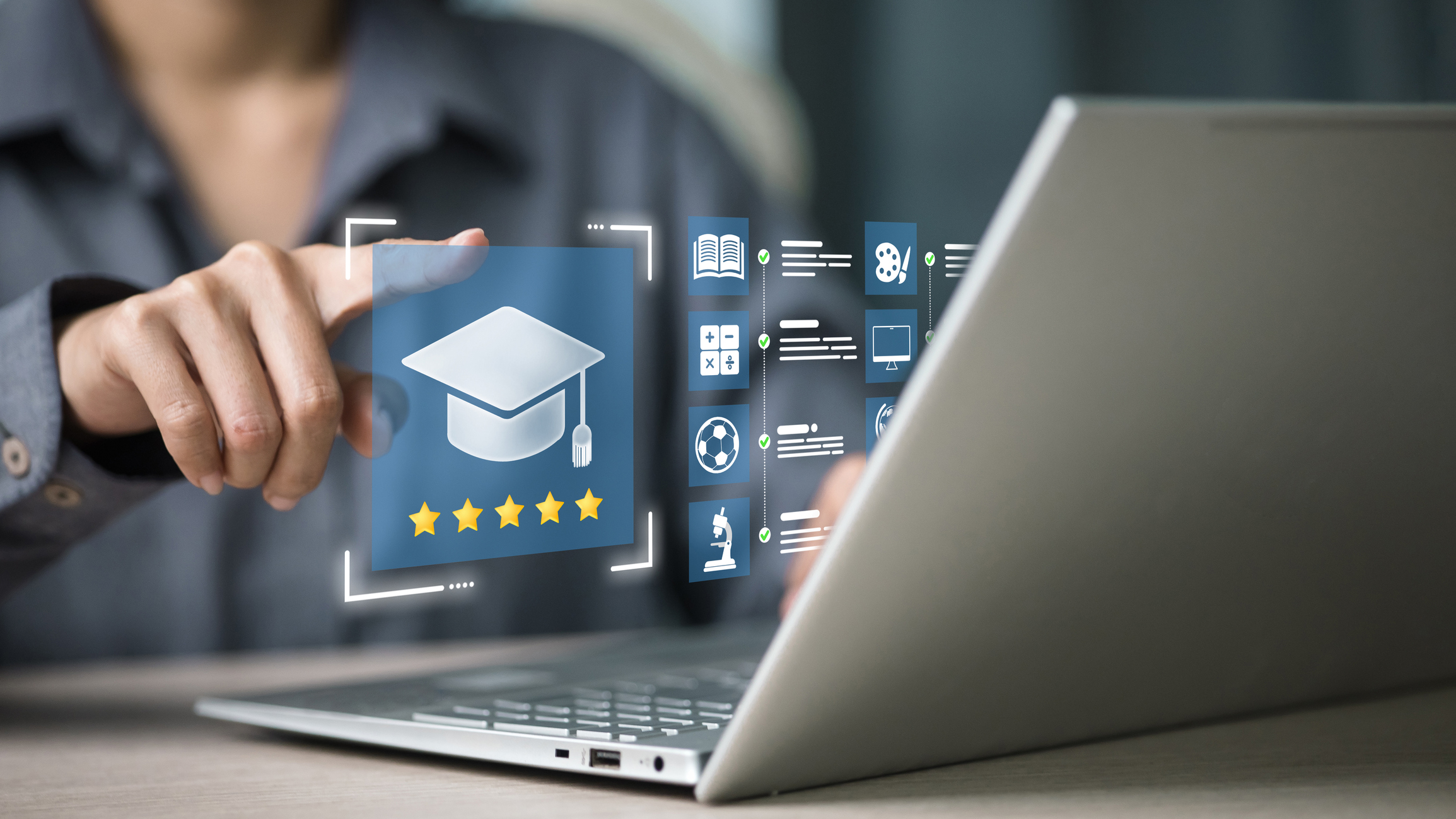 Person pointing at holographic education interface with graduation cap icon and five-star rating on laptop screen