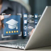 Person pointing at holographic education interface with graduation cap icon and five-star rating on laptop screen