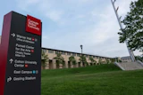 Carnegie Mellon University directional wayfinding sign on campus green space with building and sky in background