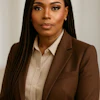 Professional headshot of woman in brown blazer and cream shirt against neutral background