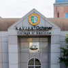 Xavier University College of Medicine building entrance with institutional seal and signage on white stone facade